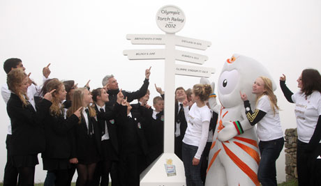 Young people from across the UK help LOCOG Board Member Jonathan Edwards and Olympic mascot Wenlock celebrate the announcement at Land's End Young people from across the UK help LOCOG Board Member Jonathan Edwards and Olympic mascot Wenlock celebrate the announcement at Land's End