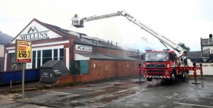 An aerial ladder is used to dampen the fire. Photo: Shropshire Fire and Rescue Service. An aerial ladder is used to dampen the fire. Photo: Shropshire Fire and Rescue Service.
