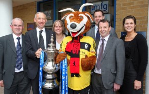 Shropshire law firm mark bucks promotion success Pictured from MFG with the Conference North play-off trophy is: Michael Payne, Robert Pearce, Sarah Baugh, Bobby the Buck, Tom Devey, Paul Rhodes and Sophie Yates.