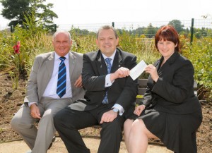 Pictured handing over the cheque are Chamber president Anthony Randall and managing director Richard Sheehan, with Lucy Proctor in the grounds of the Hospice. Pictured handing over the cheque are Chamber president Anthony Randall and managing director Richard Sheehan, with Lucy Proctor in the grounds of the Hospice.