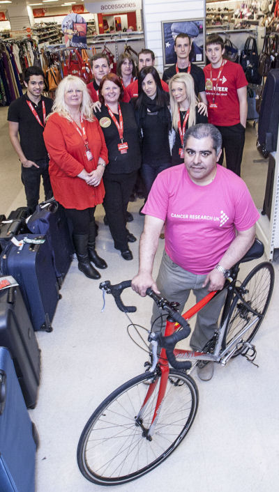 Charlie Esfandiarinia with his partner Vanessa Morgan, front left and other members of staff a TK Maxx in the Darwin Centre in Shrewsbury ready for their big charity fundraising effort.