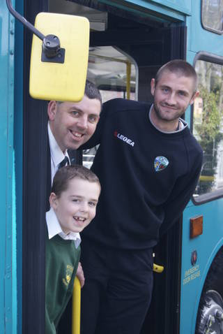 TNS player Greg Draper with Arriva bus driver Mark Hughes and son Kieran
