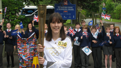Torch bearer Helen Broad with students from The Marches School. Torch bearer Helen Broad with students from The Marches School.