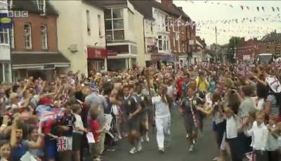 The Olympic Flame passes through a busy Newport community. Photo: BBC. The Olympic Flame passes through a busy Newport community. Photo: BBC.