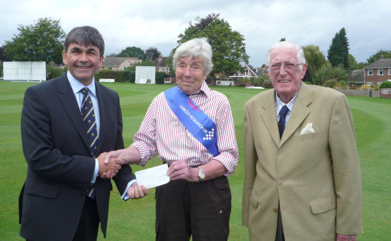 Shropshire County Cricket Club chairman Toby Shaw, left, and president Bryan Foulkes present a cheque for Â£2,500 to Paddy Willis, local representative for Cancer Research UK. 