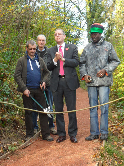 David Wright MP opening the new woodland path at the Green Wood Centre with some of the volunteers who built the path.