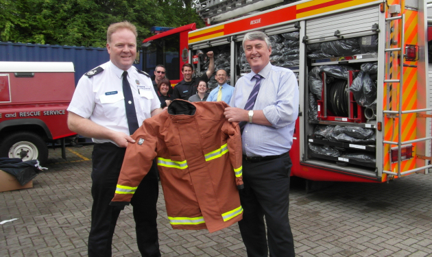 Charity aid organiser Assistant Chief Fire Officer Steve Worrall receives fire kit for Romanian firefighters from Tim Ottridge, MD of LHD Group (United Kingdom)