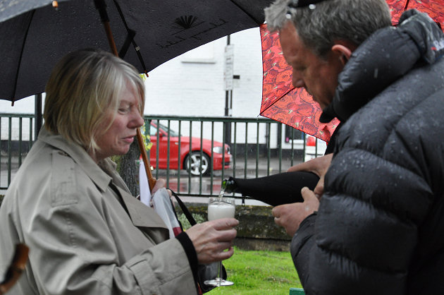 Simon Airey, ex-president of Shrewsbury Business Chamber, pours the toast for Jane Price at the Chamber’s recent unveiling of a bench dedicated to Graham Galliers near the Quantum Leap sculpture.