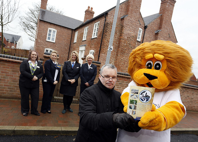 Lawley and Overdale Parish Councillor Darren Blackburn meets Louis the Lawley Lion and representatives of the developer group at St John’s Church and Lawley Farmhouse, two points of interest on the Lawley and Overdale history trail