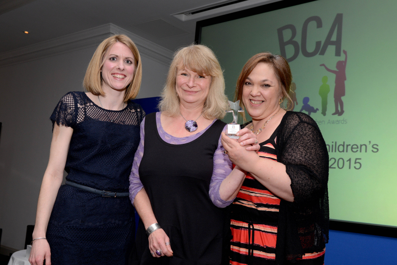 Lorna McCann, representing Beaumont Lawrence, presents Simi Epstein and Kath Jones of Hope House Children's Hospices, with the Children's Charity Award at the 2015 BCAs