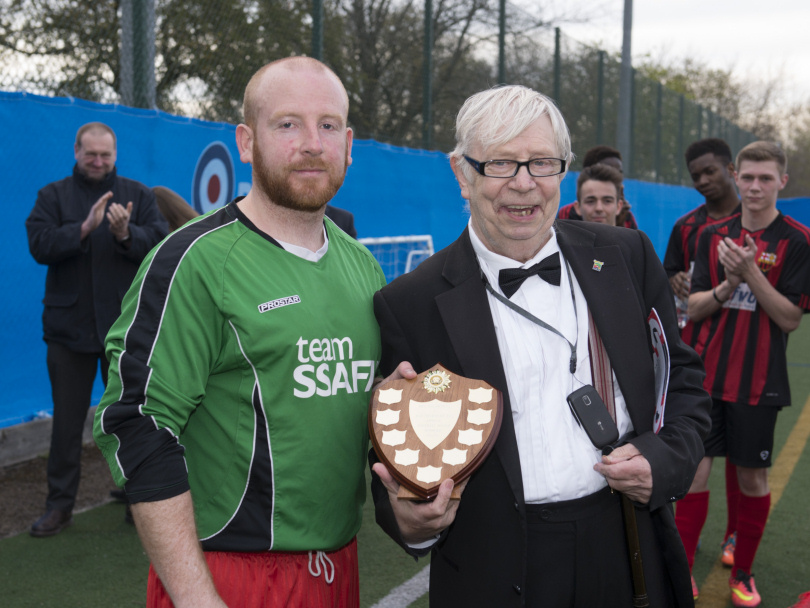 RAF Shawbury FC Manager Flight Sergeant Dan Jackson presents the annual match winners’ trophy to Neil Baldwin