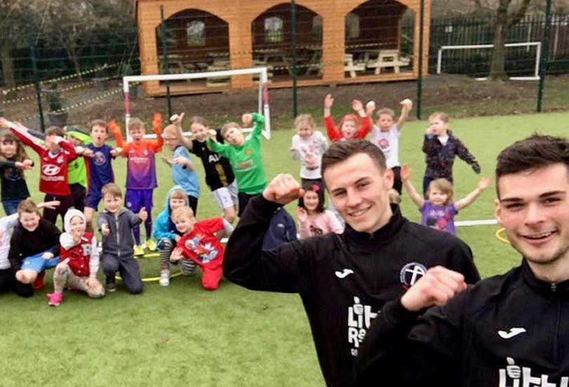 Youngsters at Newport’s Moorfield Primary School enjoying themselves at a holiday club with Crossbar apprentices Niall Flint and Ryan Oare