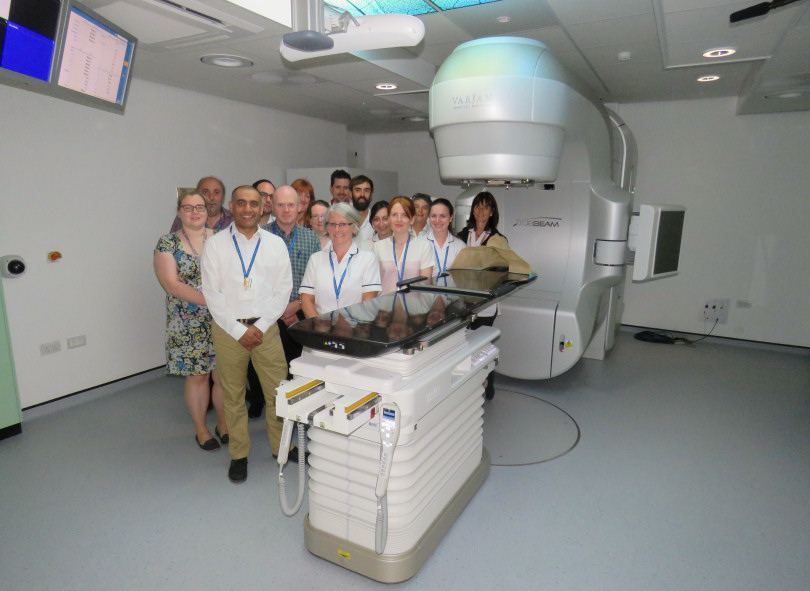 Members of staff taking a look at the new Linear Accelerator