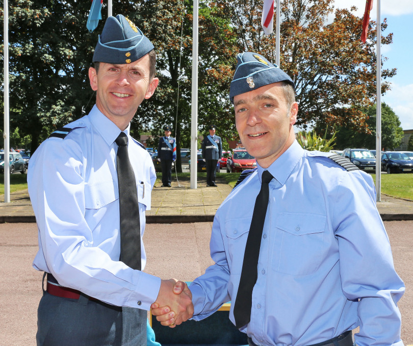 The outgoing Station Commander Air Commodore Mark Hunt hands over command to Group Captain Tone Baker
