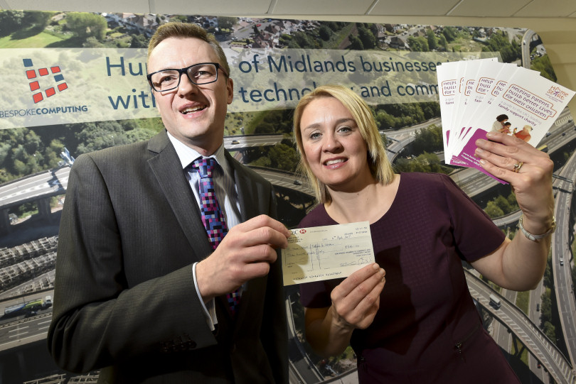 Chris Pallet from Bespoke Computing hands over the £300 donation to Julia Allinson, Fundraising Manager from Home-Start Telford & Wrekin
