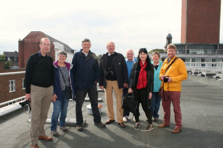 Town Guide Stan Sedman leading a group of roof-top sightseers on tour