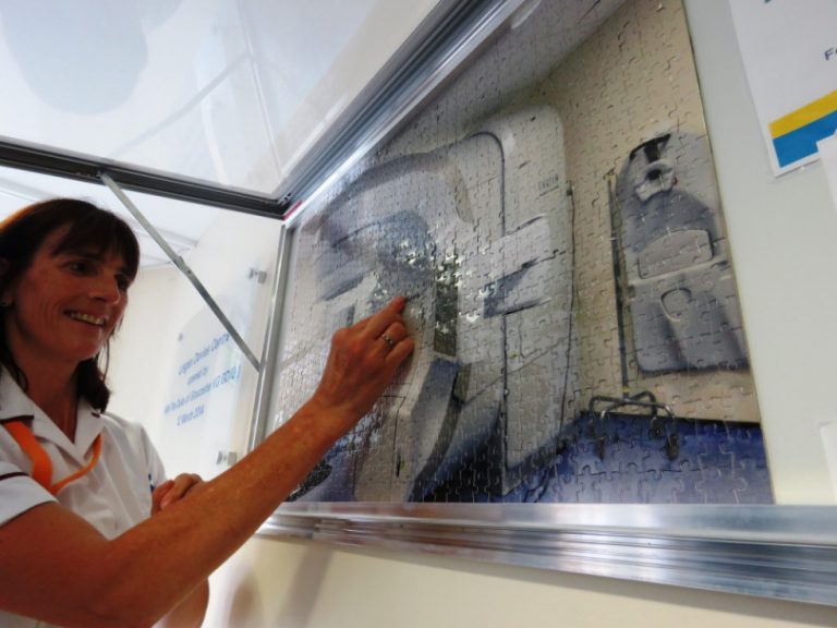 Louise Killey puts the last piece in the jigsaw puzzle