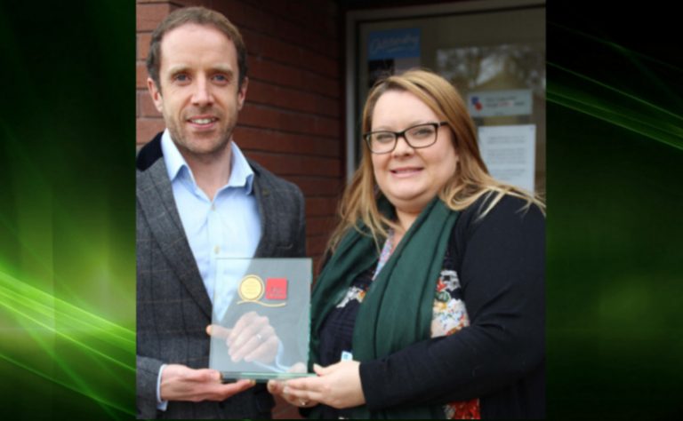Ian Jelley, deputy Chief Executive at Fair Train presents the Gold Standard award to Abi Baker, Work experience Co-ordinator at Derwen College
