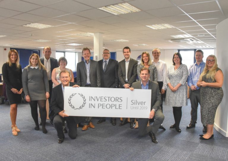 Matt Sandford, managing director of Pure Telecom, and sales director David Hayward celebrate the award with the rest of the team