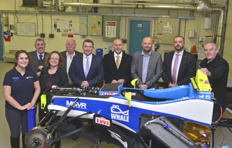 Pictured are Patrons with the F3 racing car chassis undergoing maintenance