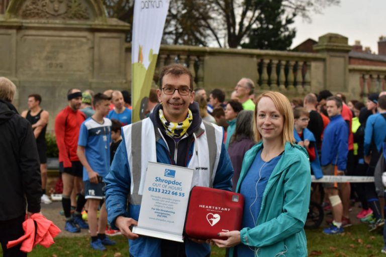 Paul Bowes, Event Director of Shrewsbury parkrun receives the defibrillator from Emma Feely, of Shropdoc. Photo: Colin Williamson