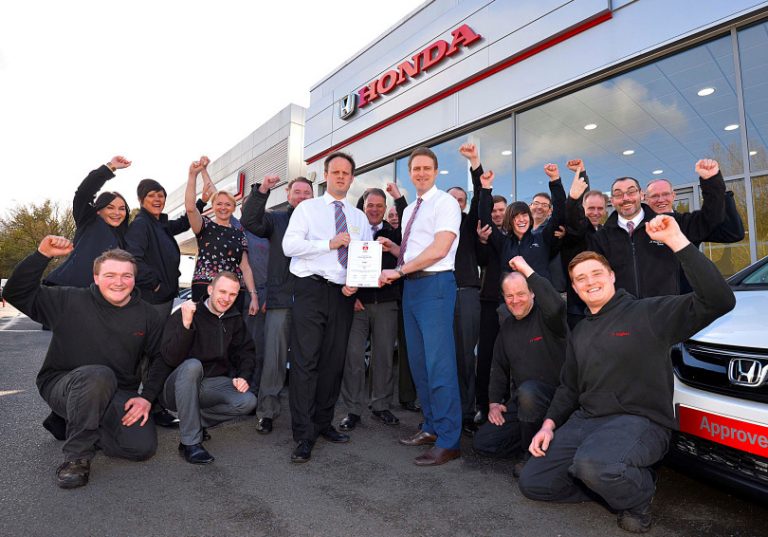 The JT Hughes team celebrate being awarded the Best Car Dealer in recent Auto Express Driver Power Awards