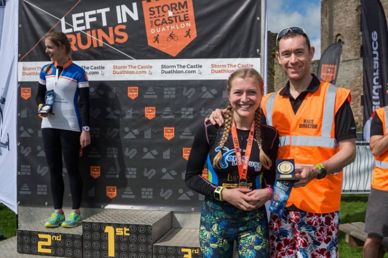 Pictured, left to right Teme Leisure Tri Club Shannon Gilbert on podium and Sister, also Teme Leisure Tri Club member, Eilish Gilbert with race director Dermott Hayes. Eilish was first in her category (females 16-24) and her sister was runner up.
