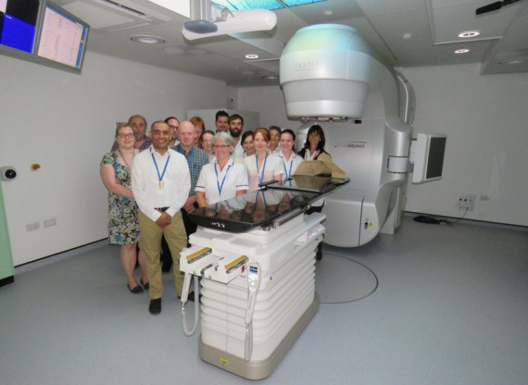 Members of staff taking a look at the new Linear Accelerator
