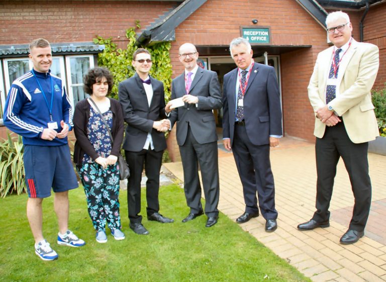 Cae Glas Lodge present Derwen College with a cheque