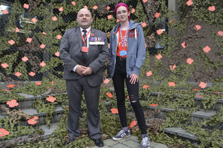 Ted Coxon and Samira Hills are pictured in front of the poppy display at London Road Campus