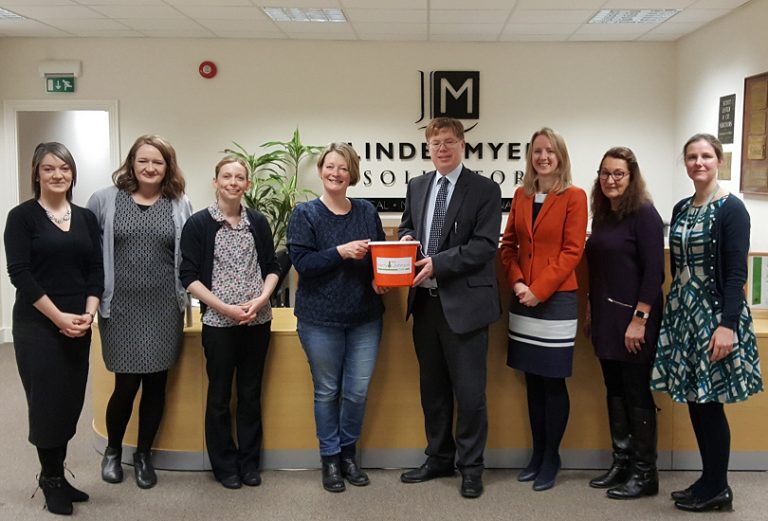 Linder Myers staff members with Sally Johnson of the Harry Johnson Trust