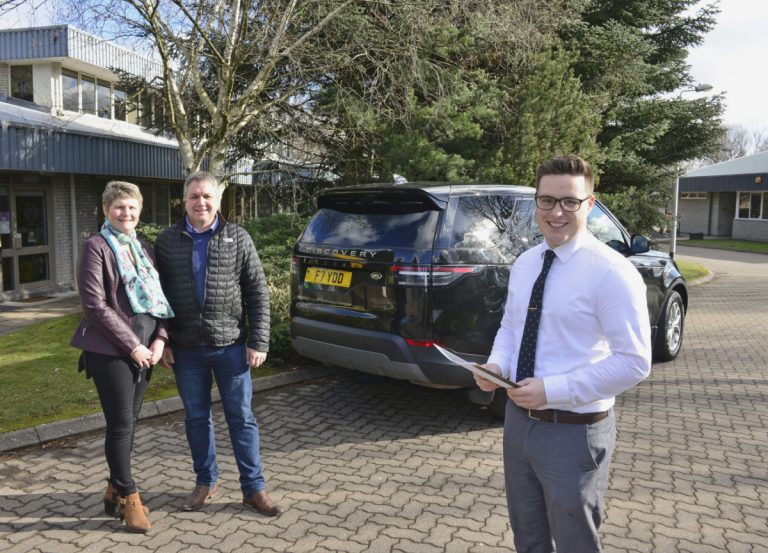 Young apprentice Ashley Roberts with Gareth and Joy Evans and their new Discovery