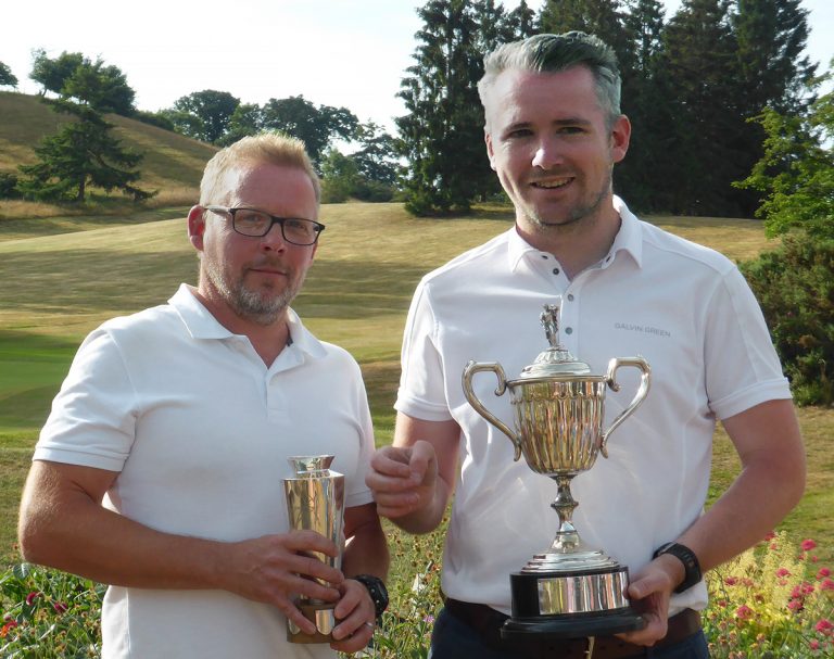 Marc Lang holding the Dickson Handicap Trophy and Steve Fitzpatrick (2018 Club Champion) holding the Wetton Scratch Cup