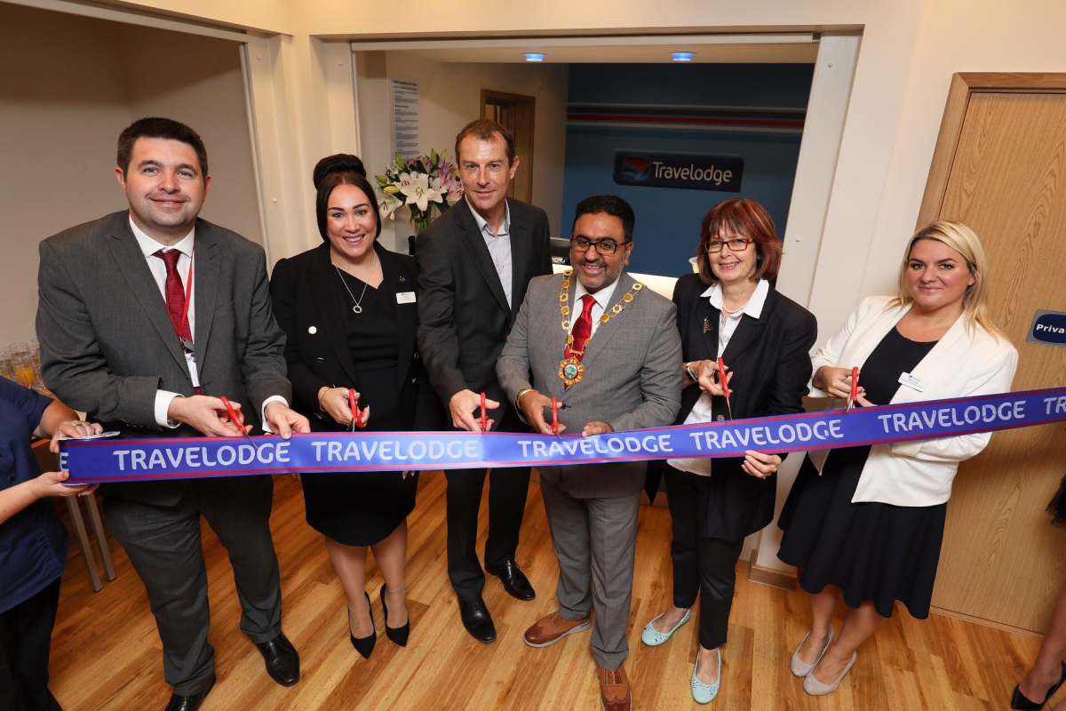 Pictured at the opening is Shaun Davies (Leader of Telford & Wrekin Council), Alex Wreford (Hotel Manager, Telford Travelodge), James Hellewell (Travelodge Chief Technology Officer), Raj Mehta (Mayor of Telford and Wrekin), Councillor Rae Evans (Cabinet Member for Tourism & Partnerships), Nichola Stevens (Regional Director Travelodge)