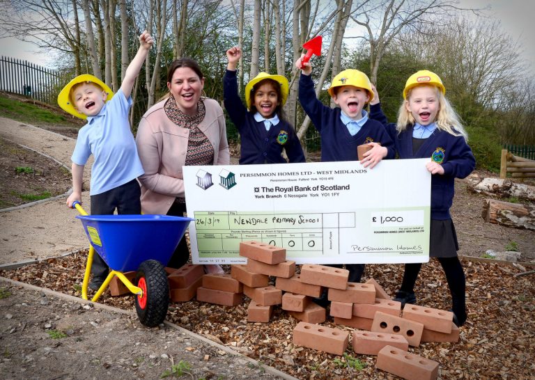 Pupils Finlay Kilford, Shanel Silva, Maddison Tidmarsh and Jack Steward join Amanda Rogers, head of sales at Persimmon Homes West Midlands, to celebrate the donation