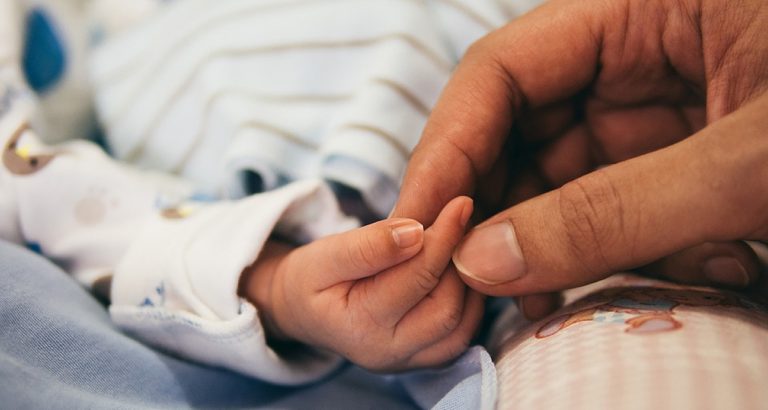 Holding baby hand - Generic