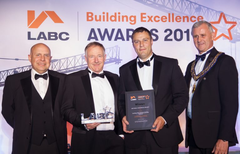 Mark Kelly (second left) and Joe Strafford (third left) from apT receive LNT Construction’s award on their behalf. Photo: Eden Photography