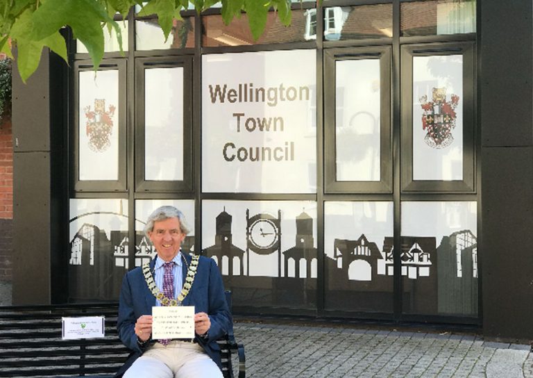 Mayor Anthony Lowe on ‘Happy to Chat’ bench outside Wellington Town Council