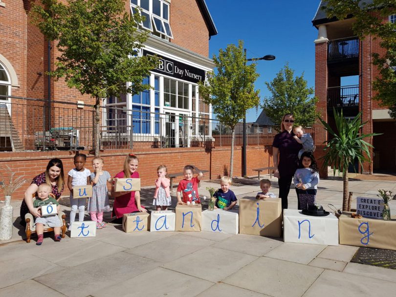 Children and staff at ABC Lightmoor celebrate their Ofsted Outstanding rating in the sunshine