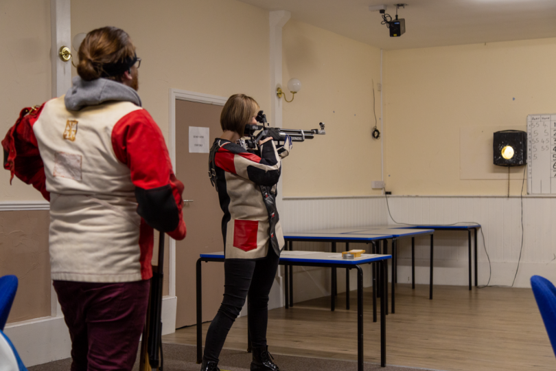 Telepost's Dan Pritchard looks on as Cock Inn B's Sue Brown hits a clean bullseye. Photo: Bob Griffiths