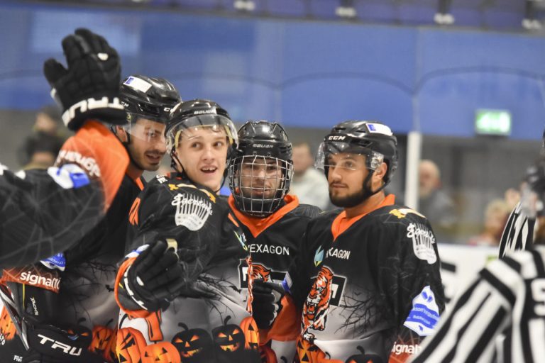 Players celebrate with Oliver after he scores for Tigers. Photo: Steve Brodie