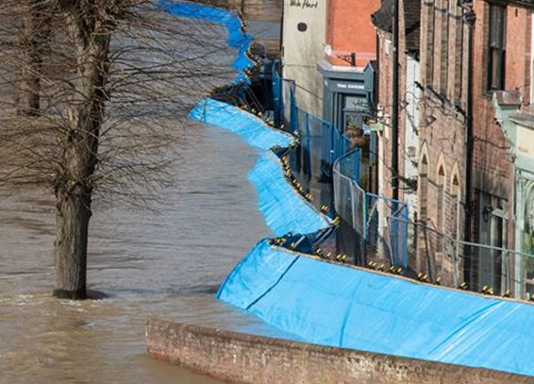 The flood barriers along the Wharfage moved after being overwhelmed by the volume of flood water. Photo: Barry Jones