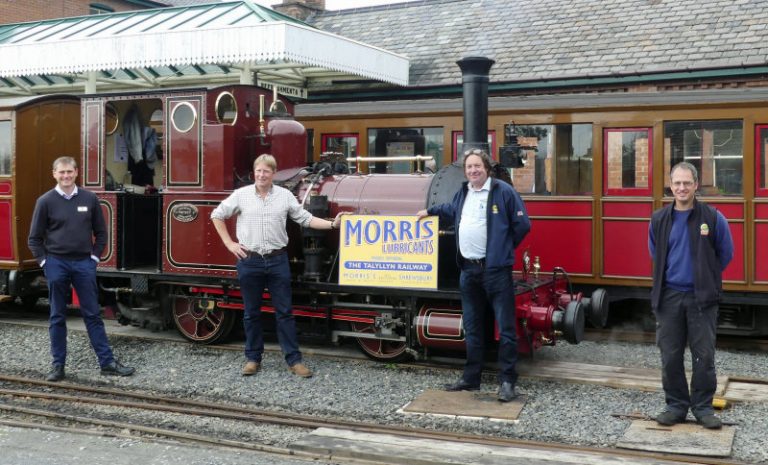 Morris Lubricants’ executive chairman Andrew Goddard (second form left) and the company’s heritage account manager Keiron Thorogood hold one of the new signs watched by Talyllyn Railway’s general manager Stuart Williams (left) and engineering manager Chris Smith (right)