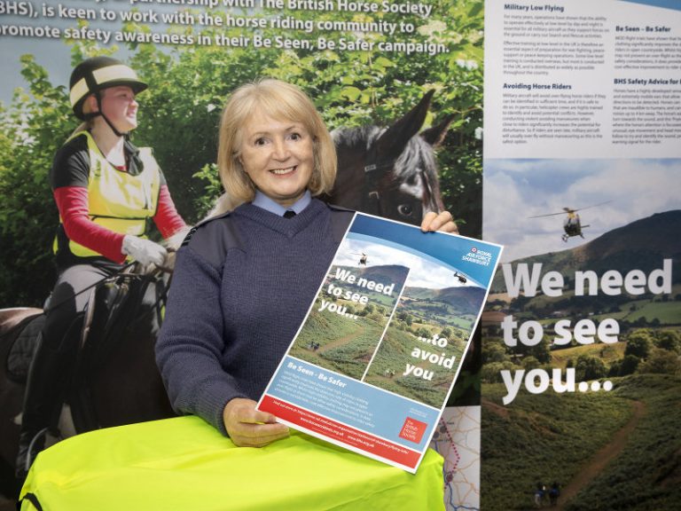 Squadron Leader Kim Leach with a campaign poster. Photo: MOD Crown Copyright 2020