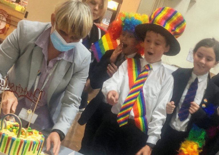 Julie Johnson (Head of School) cuts the special rainbow cake with Jay Olszowy, Charlotte Johnson, Oliver Booth and Izzy Mills