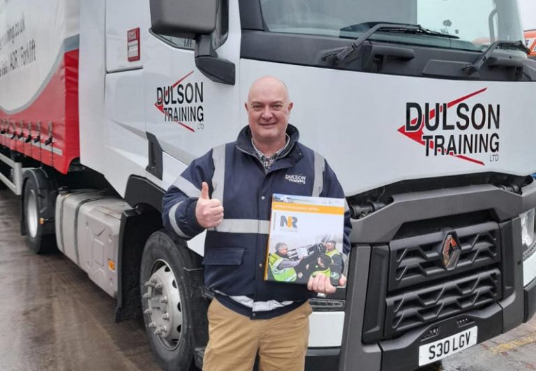 Austen is a new instructor who is delivering LGV training. Proudly holding his LGV National Register of Instructors (NRI) certificates and literature. Standing with one of the new Dulson Training Renault Class 1 training vehicles