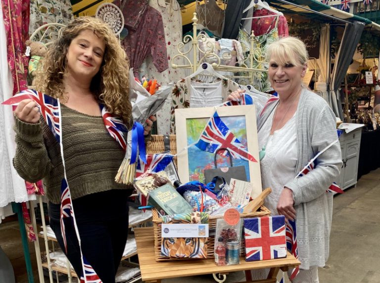 Market traders Libby Gliksman and Teri Trickett with one of the market Jubilee hampers that can be won this week