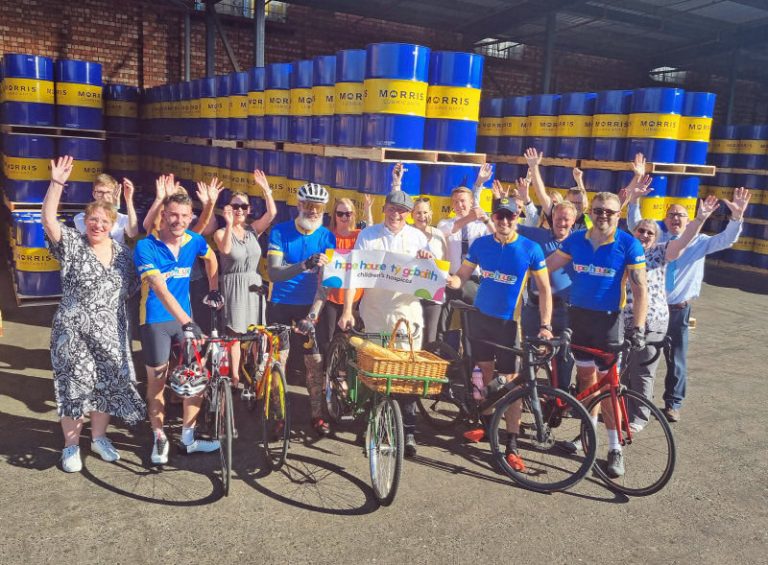 The Morris Lubricants cycle team Billy Salter, Kim Marmaras, Andrew Goddard, Owen Lloyd and Dan Stanley (left to right) celebrating their successfully completed charity challenge with workmates