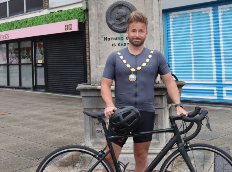 Mayor of Great Dawley Town Council Cllr Ian Preece with his bike standing next to the Captain Webb Monument in Dawley