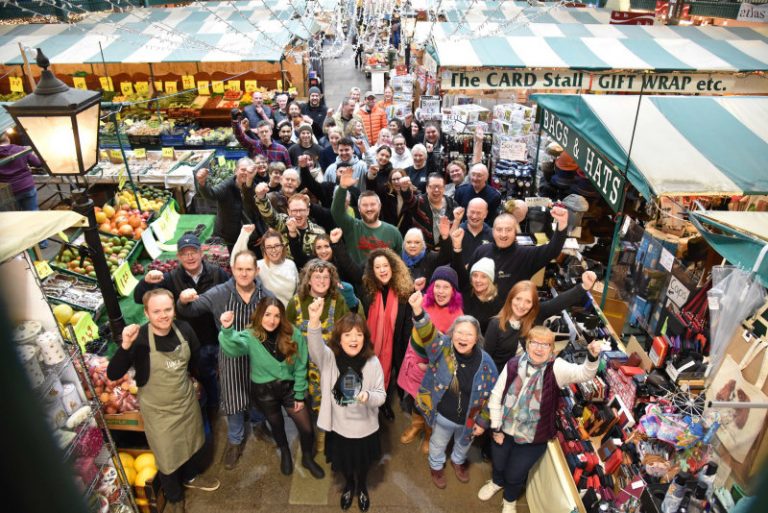 Kate Gittins, with traders celebrating the win at Shrewsbury Market Hall